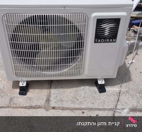 יחידת מיזוג אוויר חיצונית על גג בטון